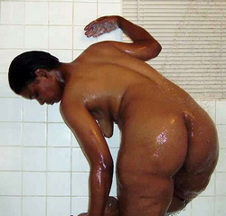 Wet black skin in the warm bathroom